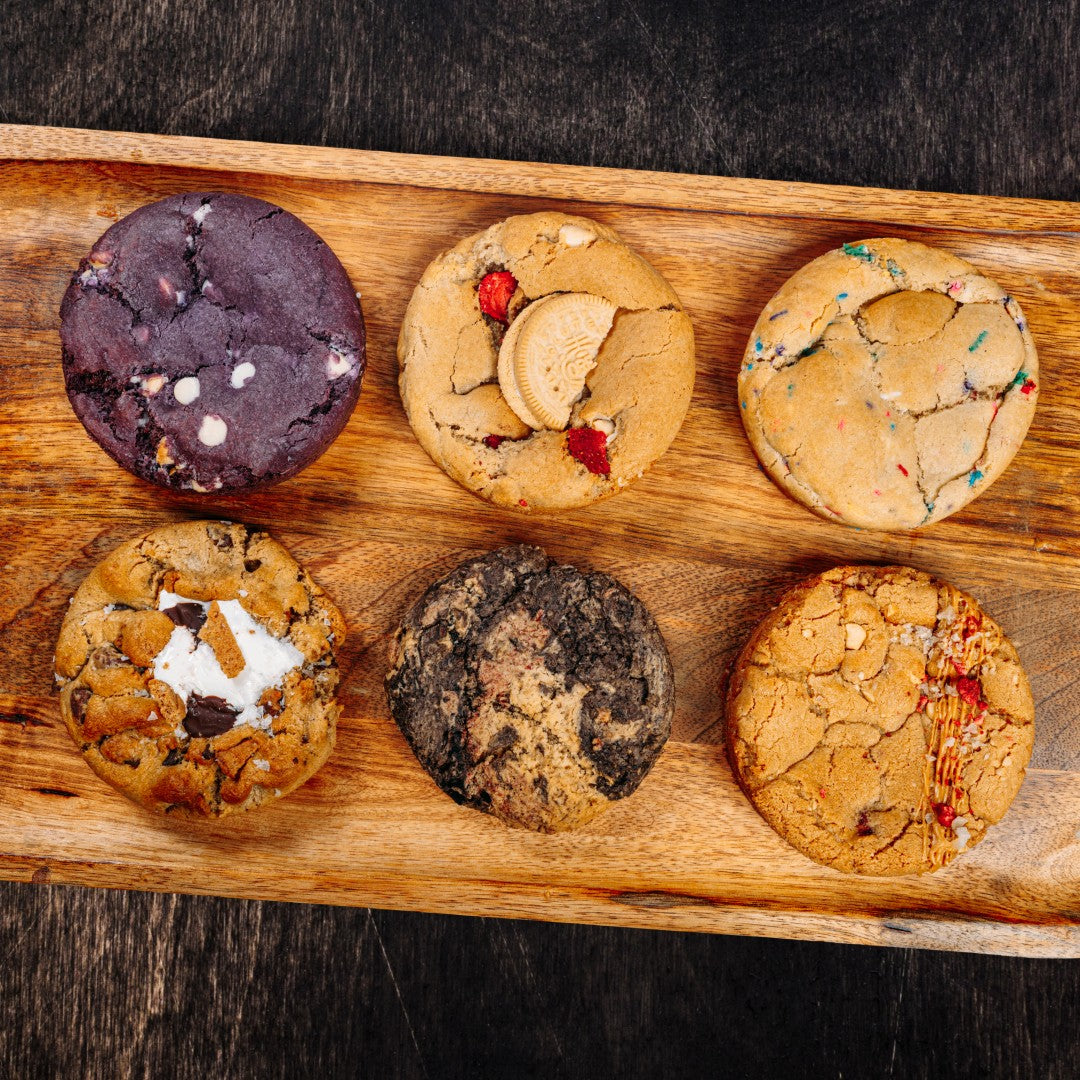 Twelve assorted cookies from Bundle’s 12 pack are displayed on a wooden tray, making an ideal dummy product for your bundle page or Bundle Builder app display.